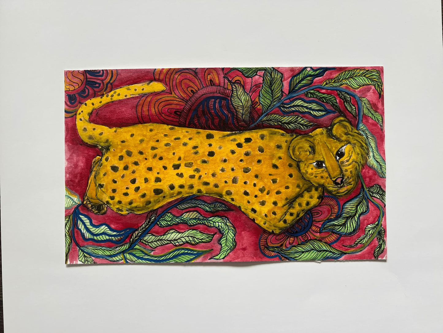 Colorful artwork of a cheetah on a pink background with green leaves
